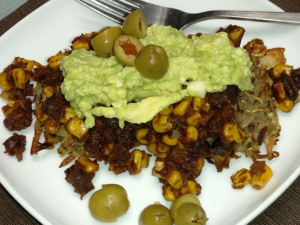 Latke tacos topped with guacamole and green olives